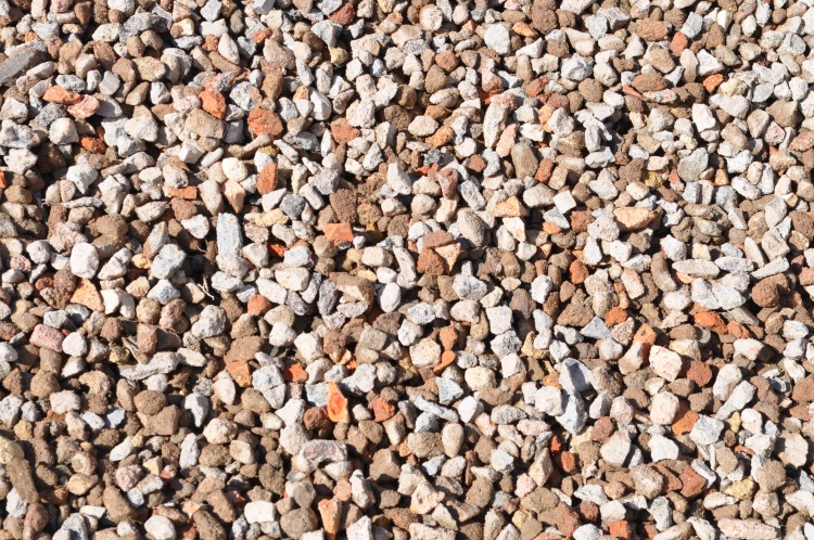 A pile of 10mm recycled aggregate, consisting of crushed concrete and brick rubble, showcased on Parklea Sand and Soil's webpage. The aggregate appears in various shades of gray, with uneven textures and angular edges. It is commonly used in construction projects as a sustainable alternative to traditional aggregates, offering both environmental benefits and cost-effectiveness. The image conveys the versatility and potential applications of the recycled aggregate, highlighting its potential for use in pathways, driveways, and general landscaping projects.