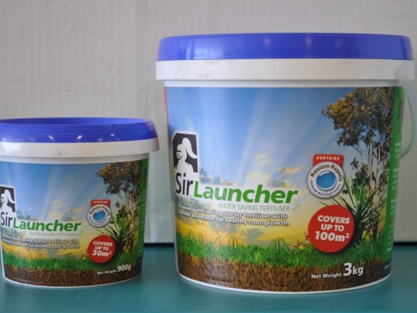 A bag of Sir Launcher water-saving fertiliser on a green lawn. The fertilizer is specifically formulated to promote water retention in the soil, helping plants thrive and reducing water consumption. It is suitable for use on lawns, gardens, and other outdoor areas. For sale at Parklea Sand & Soil Australia.