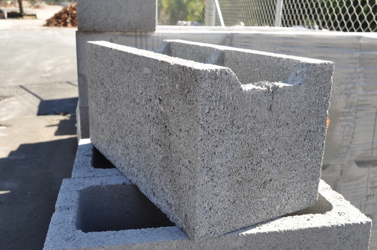 A stack of grey Besser blocks, each measuring 200mm in width. The blocks are made of durable concrete and feature a smooth surface texture. They are commonly used in construction projects for creating sturdy walls and structures. The image showcases the uniform color and shape of the blocks, highlighting their versatility and potential for various building applications.