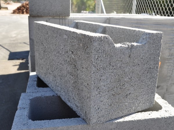 A stack of grey Besser blocks, each measuring 200mm in width. The blocks are made of durable concrete and feature a smooth surface texture. They are commonly used in construction projects for creating sturdy walls and structures. The image showcases the uniform color and shape of the blocks, highlighting their versatility and potential for various building applications.