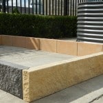 A close-up image of Lock-In Garden Edge Blocks displayed on a webpage. The blocks are made of durable and weather-resistant material, featuring a textured surface and interlocking design. They have a neutral color tone that complements any garden style. These blocks provide a secure and easy-to-install solution for creating clean and defined edges in garden beds, pathways, or borders. Enhance the aesthetics of your outdoor space with these versatile and low-maintenance garden edge blocks from Parklea Sand & Soil. For sale at Parklea Sand & Soil Australia.