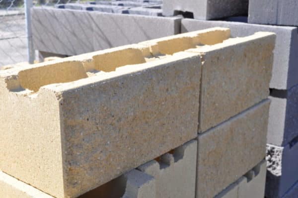 A close-up image of a split face block from the 200mm series. The block has a textured surface with a split pattern, showcasing its natural stone-like appearance. The color of the block is a warm, earthy tone, providing a rustic and modern aesthetic for construction projects. For sale at Parklea Sand & Soil Australia.