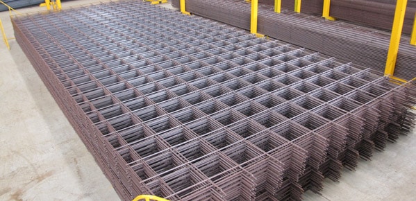 A a portfolio of reinforced steel and concrete mesh by Parklea Sand & Soil. The image showcases a variety of steel mesh rolls neatly stacked in rows. The mesh is designed to provide structural reinforcement and support for concrete projects, ensuring durability and strength. The rolls are made from high-quality materials, offering reliable performance and easy installation. Parklea Sand & Soil specializes in supplying top-notch construction materials for various applications.