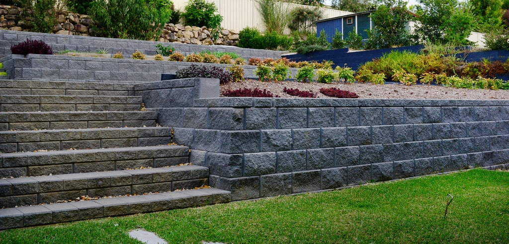 Hastings Blocks are a mortar-less block system designed to create a natural aesthetic. The four natural hues of Charcoal, Alpine, Sepia and Beach, lend a realistic and appealing finish to each block. These structurally sound blocks are perfect for any ‘do it yourself’ project. They can be used to design straight walls, curves, corners and stairs. When engineered these walls can be built up to 3 metres in height. Supplies at Parklea Sand and Soil Australia.
